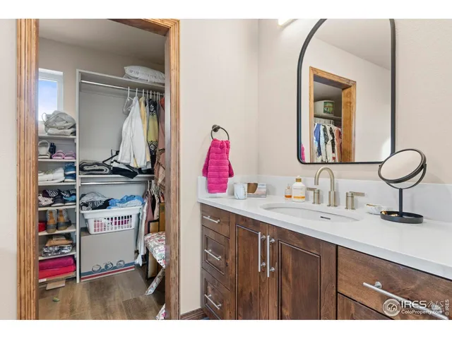 a bathroom with a sink mirror and vanity