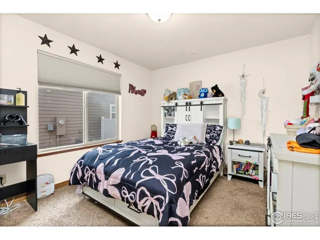 a bedroom with a bed next to a large window with the outer view