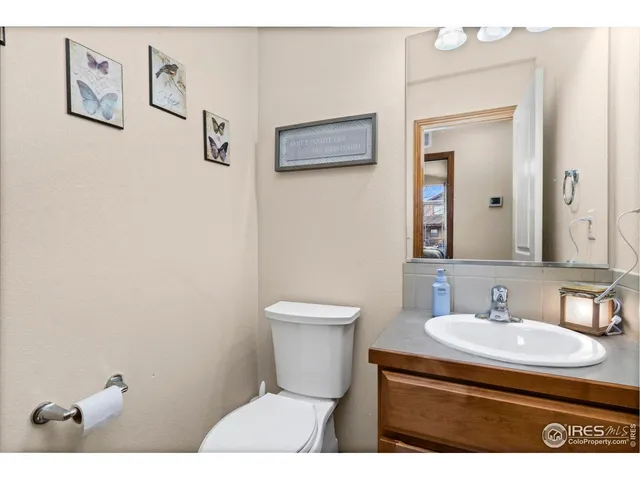 a bathroom with a sink toilet and a mirror