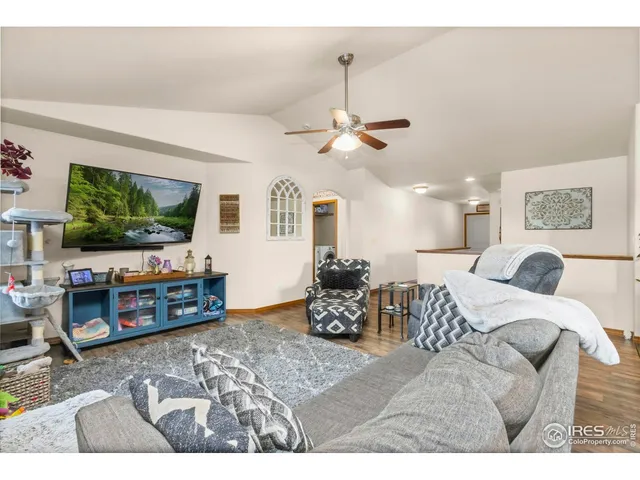 a bedroom with furniture and a flat screen tv