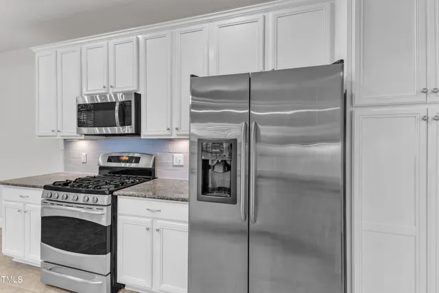 a kitchen with cabinets and stainless steel appliances