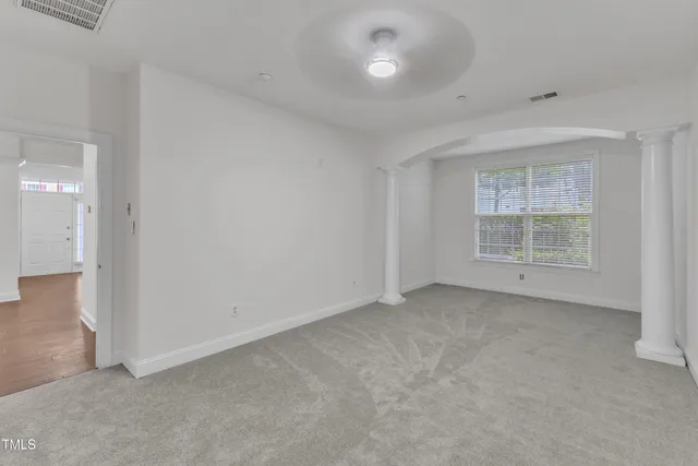 an empty room with windows and entrance