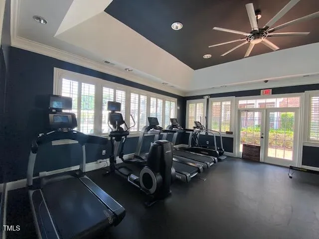 a living room with furniture gym equipment and a large window