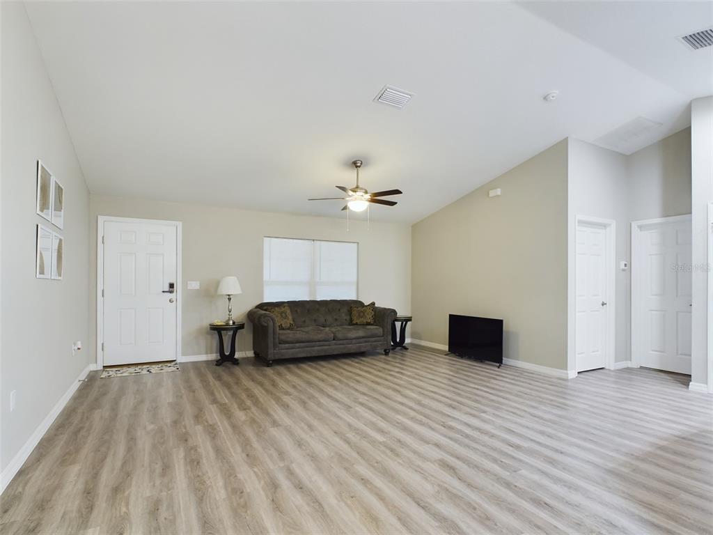 10102 Southwest 188th Circle Dunnellon, FL 34432 - Photo 6 of 17 a bedroom with a bed and a chandelier