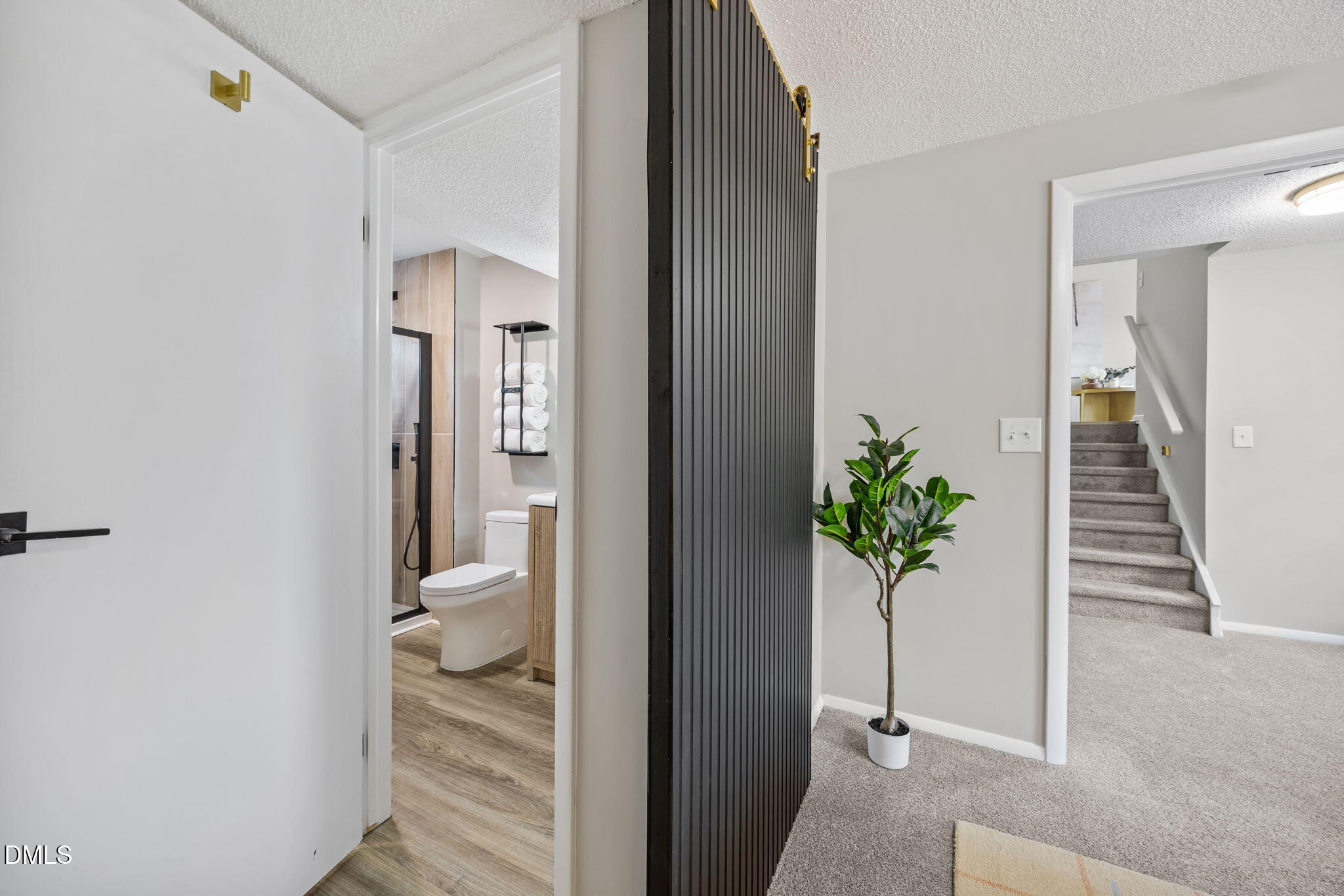 7809 Kitty Lane Raleigh, NC 27615 - Photo 16 of 29 a view of a hallway with wooden floor and a living room