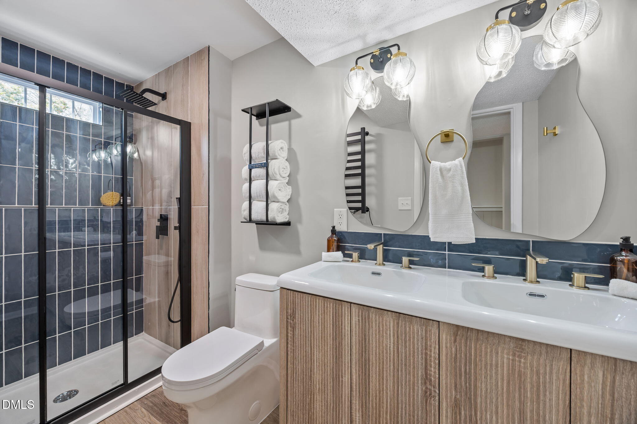 7809 Kitty Lane Raleigh, NC 27615 - Photo 17 of 29 a bathroom with a double vanity sink toilet mirror and shower