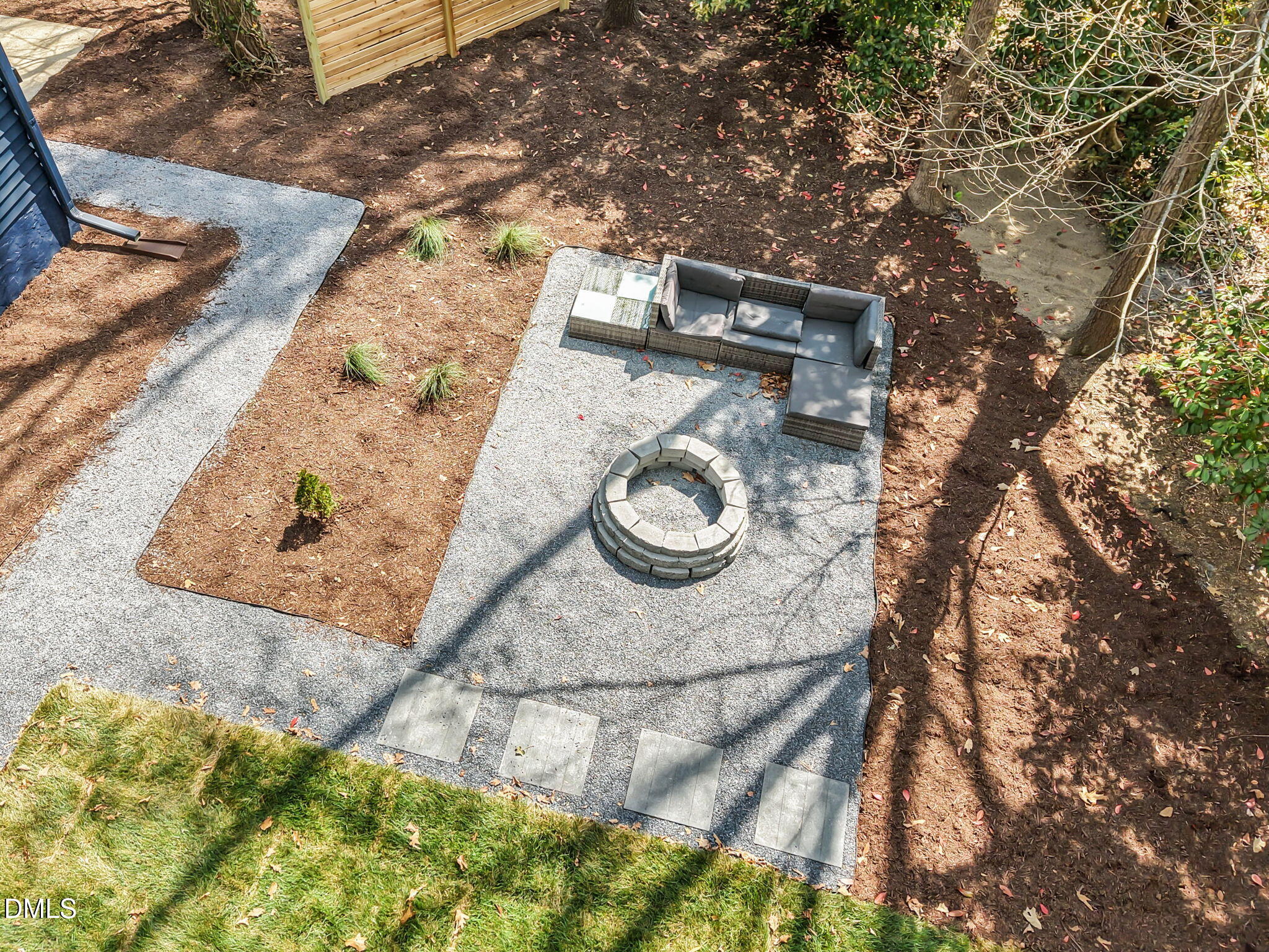 7809 Kitty Lane Raleigh, NC 27615 - Photo 21 of 29 a backyard of a house with white wall and a large tree