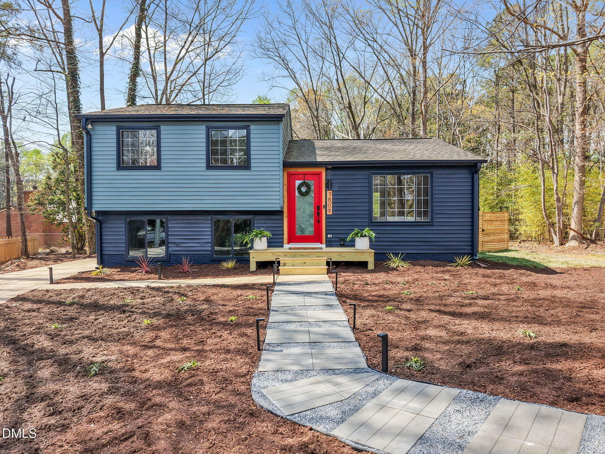 7809 Kitty Lane Raleigh, NC 27615 - Photo 24 of 29 a front view of a house with a yard and garage
