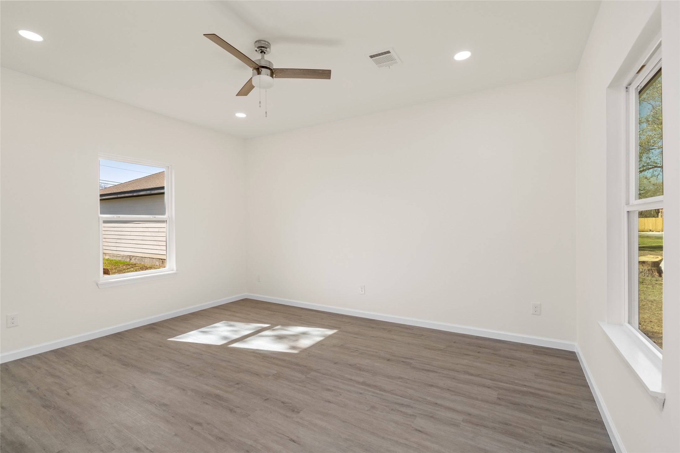 4656 North Teague Street Rosharon, TX 77583 - Photo 24 of 41 Generously sized primary bedroom with ceiling fan and serene backyard views.