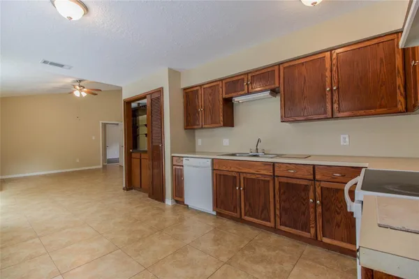 a kitchen with stainless steel appliances granite countertop a sink and cabinets