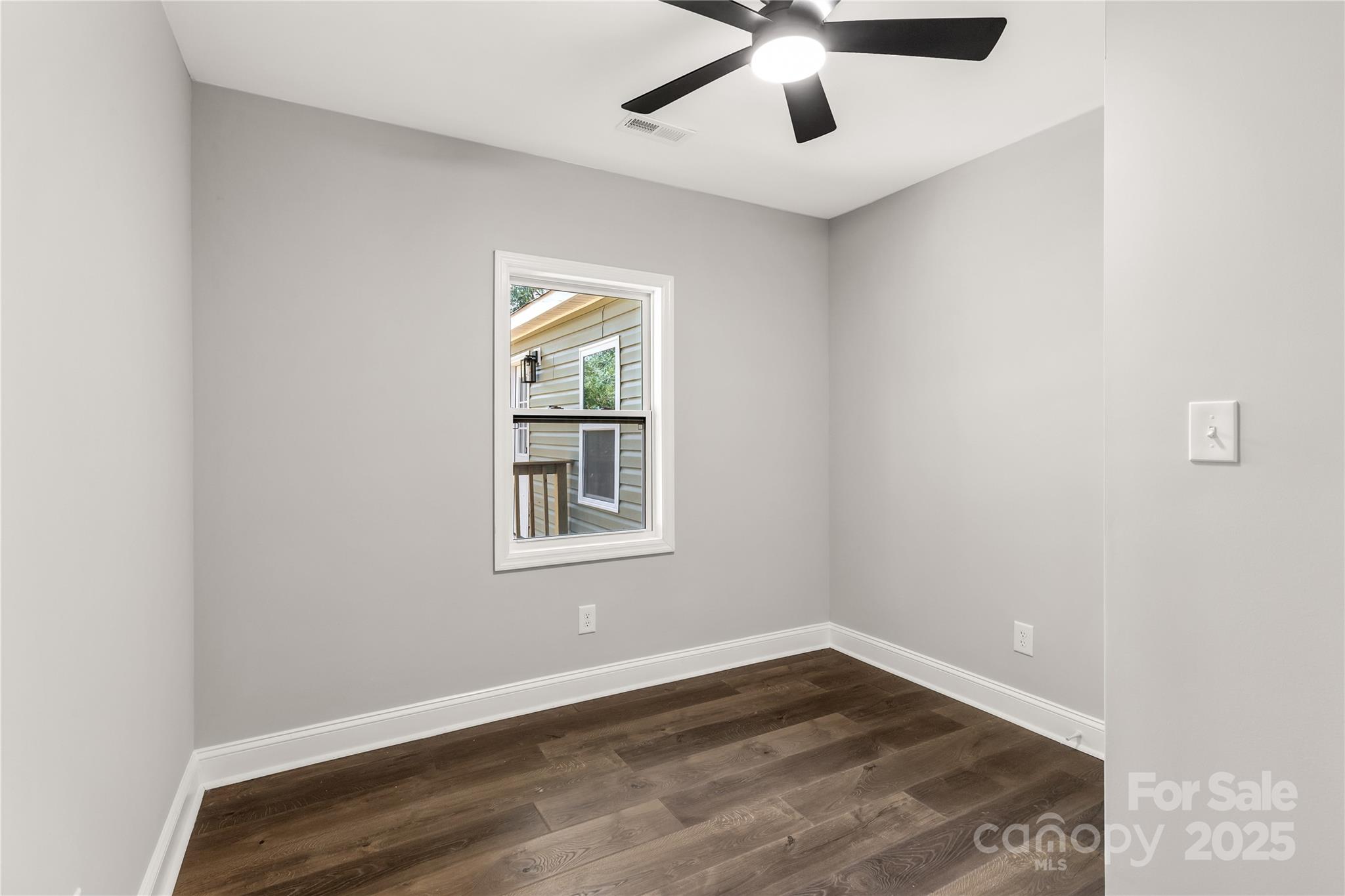 951 Confederate Avenue Lancaster, SC 29720 - Photo 15 of 29 an empty room with a window and a ceiling fan
