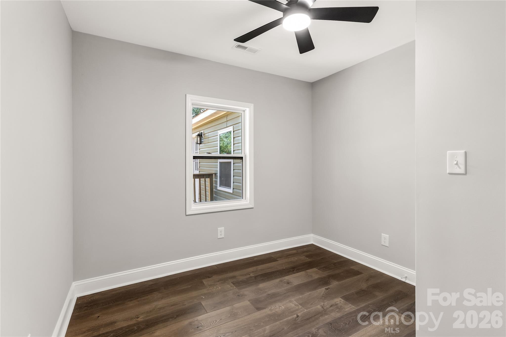 951 Confederate Avenue Lancaster, SC 29720 - Photo 15 of 29 an empty room with a window and wooden floor