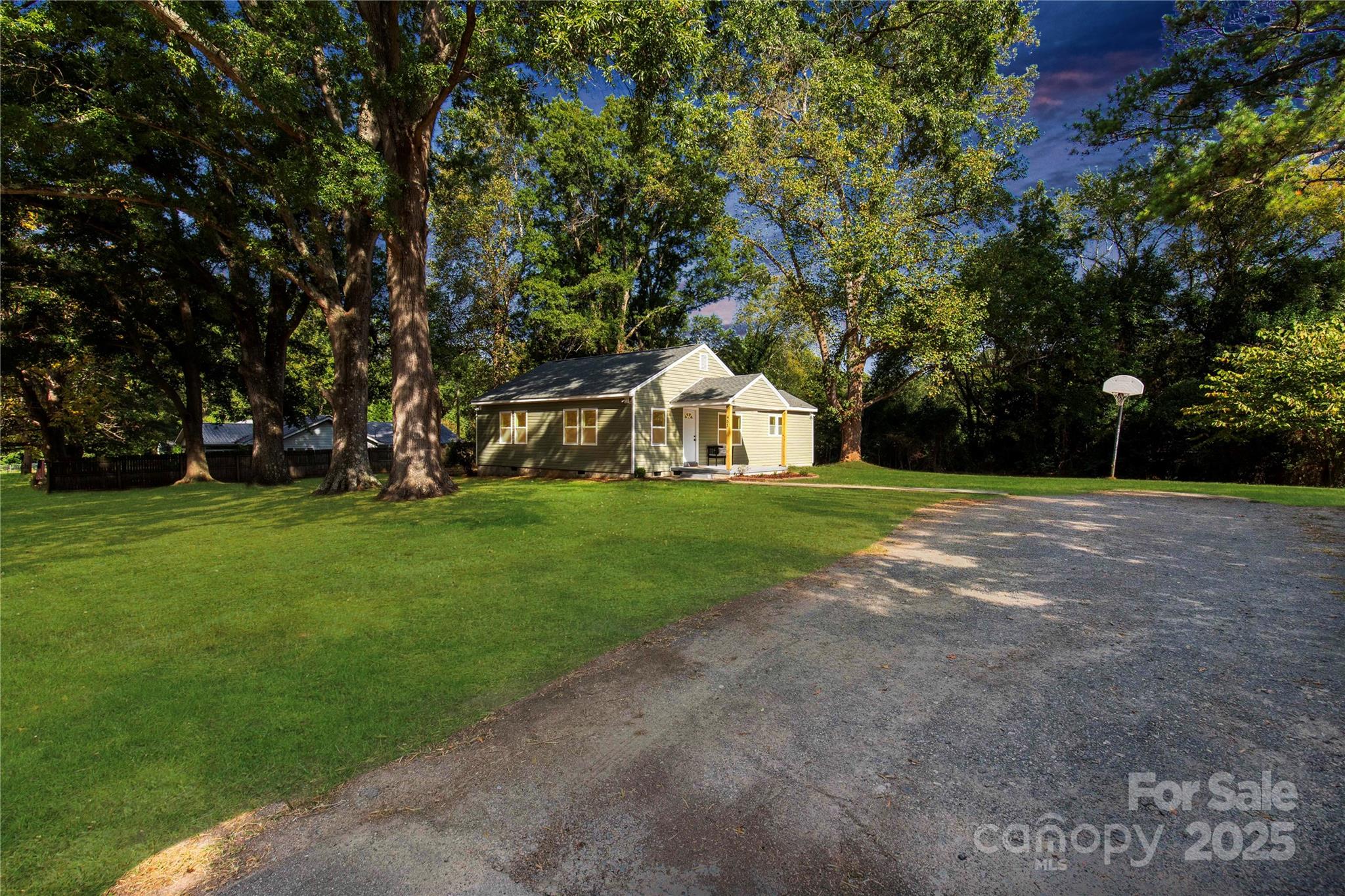 951 Confederate Avenue Lancaster, SC 29720 - Photo 3 of 29 a white house with a big yard and large trees