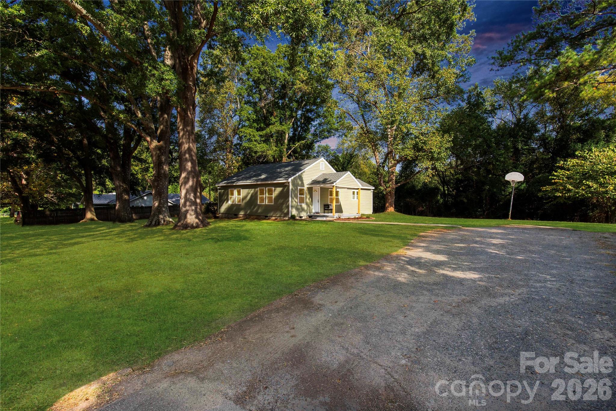 951 Confederate Avenue Lancaster, SC 29720 - Photo 4 of 29 a white house with a big yard and large trees