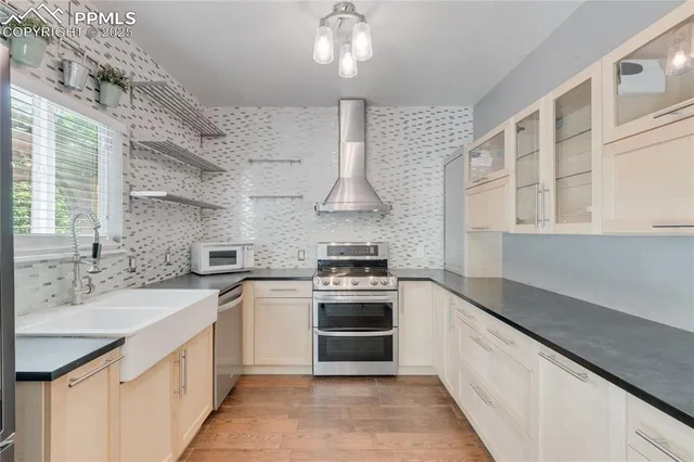 a kitchen with stainless steel appliances a stove sink and cabinets