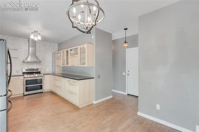 a kitchen with granite countertop white cabinets and stainless steel appliances