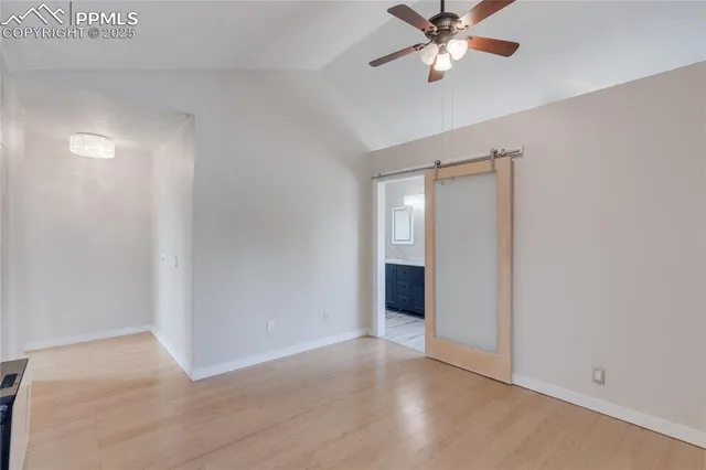 a view of an empty room with a ceiling fan