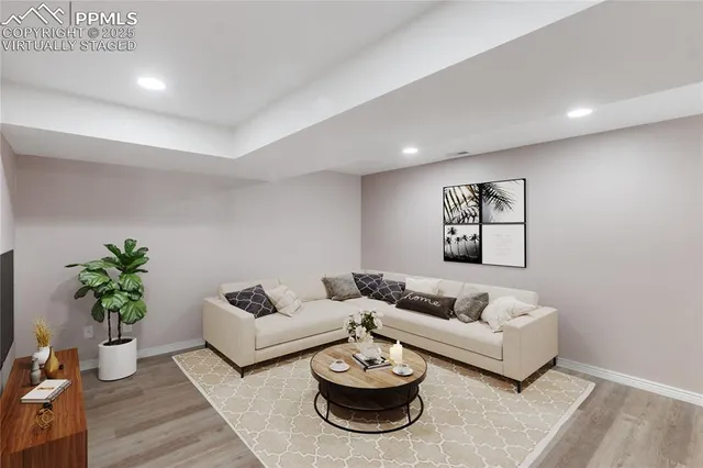a living room with furniture and a potted plant