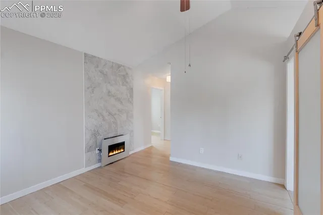 a view of an empty room with a fireplace