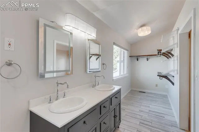 a bathroom with a sink double vanity and a mirror