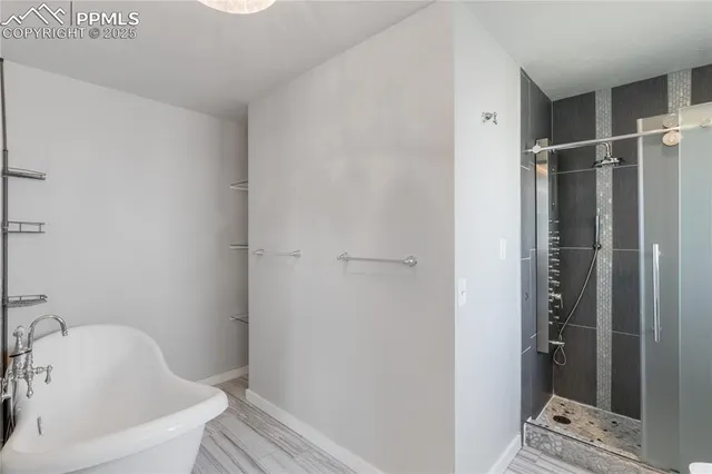 a bathroom with a tub and shower