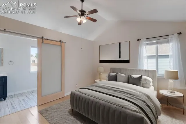 a bedroom with a large bed and a window