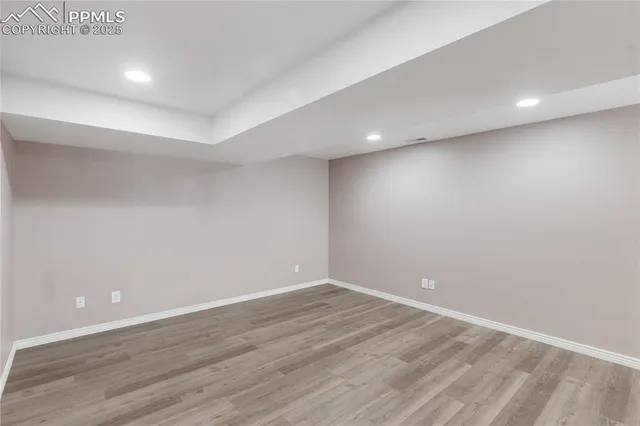 a view of room with wooden floor and natural light