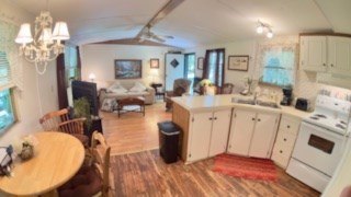 19 My Own Road Blairsville, GA 30512 - Photo 5 of 16 a very nice looking open kitchen with granite countertop a sink dishwasher a dining table and chairs with wooden floor