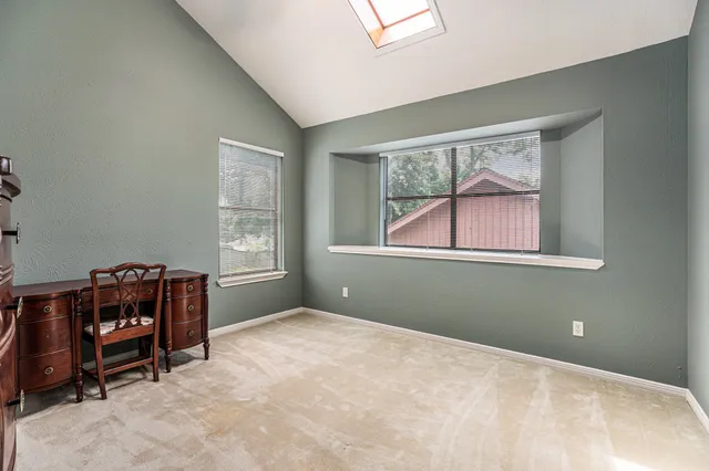 a bedroom with window and a bed