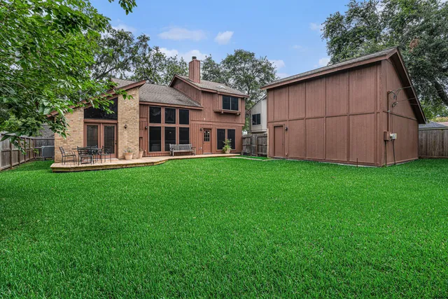 a view of a house with a yard and sitting area