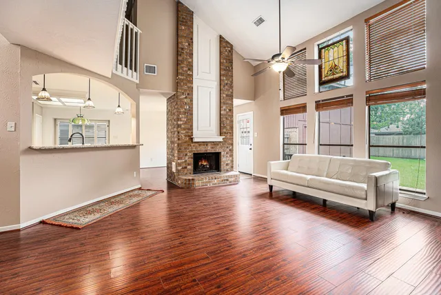 a living room with furniture and a wooden floor
