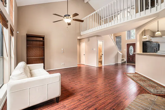 a living room with furniture and a wooden floor