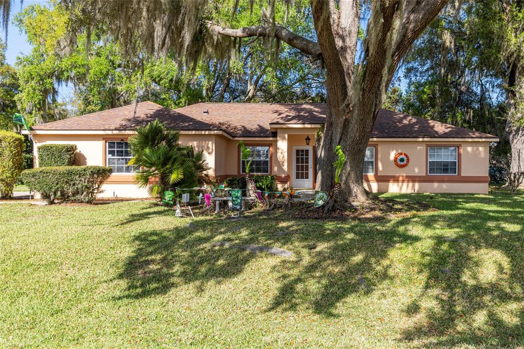 a view of a house with a tree in a yard
