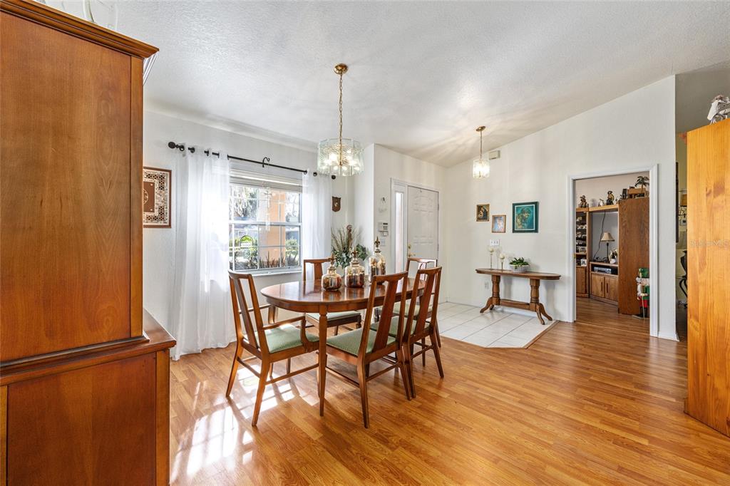 10090 Southwest 78th Court Ocala, FL 34476 - Photo 12 of 52 a view of a dining room with furniture and wooden floor
