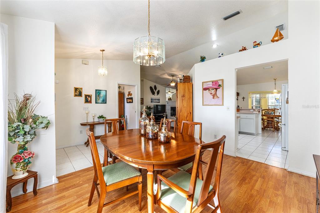 10090 Southwest 78th Court Ocala, FL 34476 - Photo 13 of 52 a view of a dining room with furniture and wooden floor