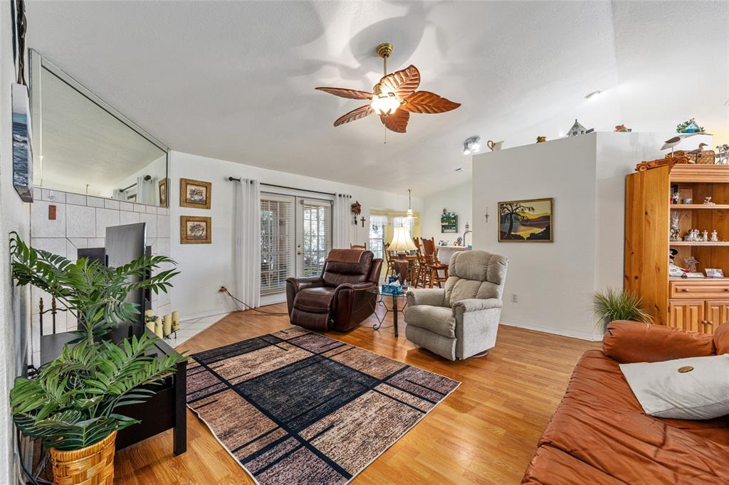 10090 Southwest 78th Court Ocala, FL 34476 - Photo 15 of 52 a living room with patio furniture and a potted plant