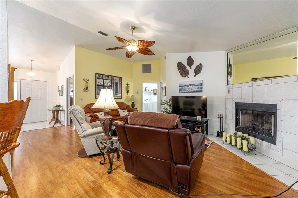 10090 Southwest 78th Court Ocala, FL 34476 - Photo 16 of 52 a living room with furniture and a fireplace