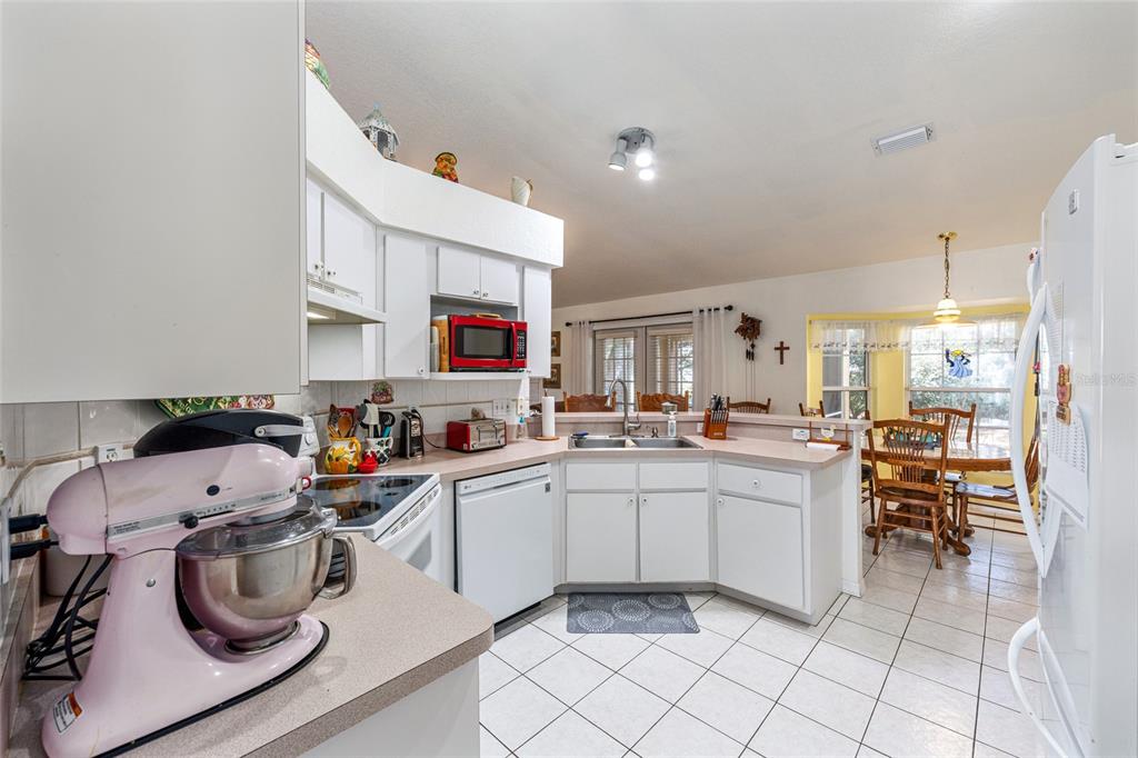 10090 Southwest 78th Court Ocala, FL 34476 - Photo 20 of 52 a kitchen with a sink a stove and cabinets