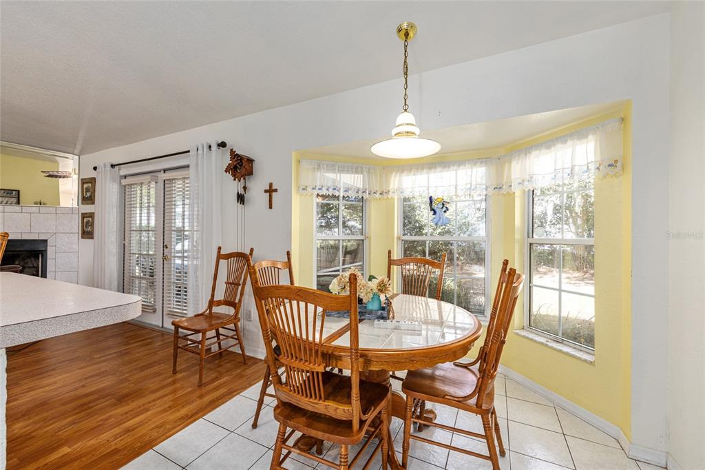 10090 Southwest 78th Court Ocala, FL 34476 - Photo 21 of 52 a dining room with furniture window and wooden floor