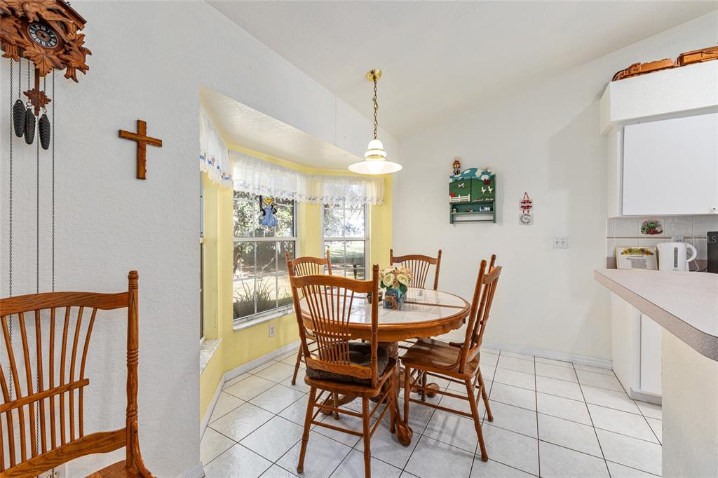 10090 Southwest 78th Court Ocala, FL 34476 - Photo 22 of 52 a view of a dining room with furniture
