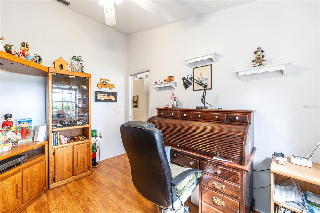 10090 Southwest 78th Court Ocala, FL 34476 - Photo 32 of 52 a workspace with furniture and wooden floor