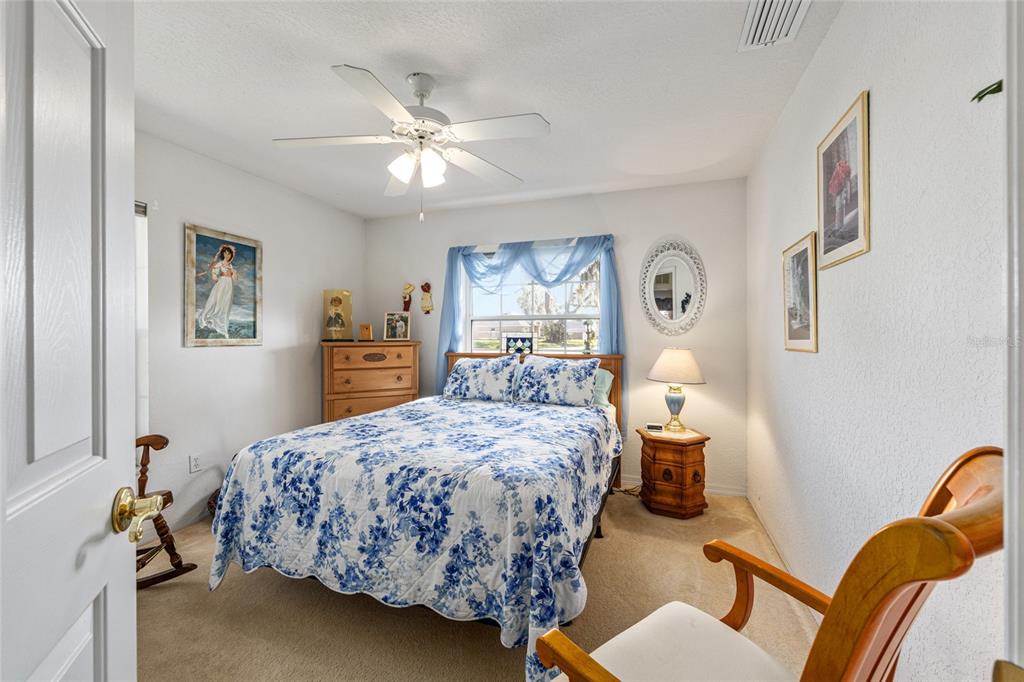 10090 Southwest 78th Court Ocala, FL 34476 - Photo 33 of 52 a bedroom with a bed wooden floor and window