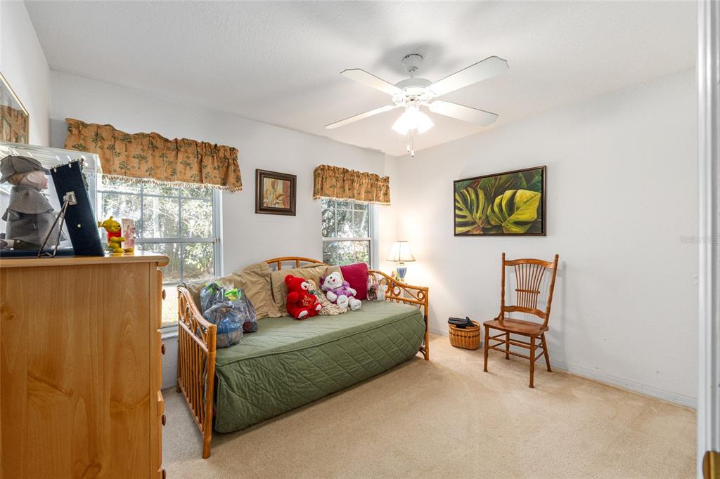 10090 Southwest 78th Court Ocala, FL 34476 - Photo 36 of 52 a living room with furniture and a flat screen tv