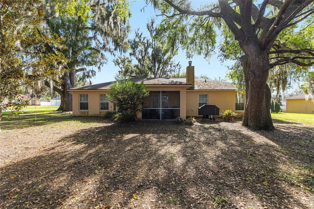 10090 Southwest 78th Court Ocala, FL 34476 - Photo 6 of 52 a view of a house with backyard and trees