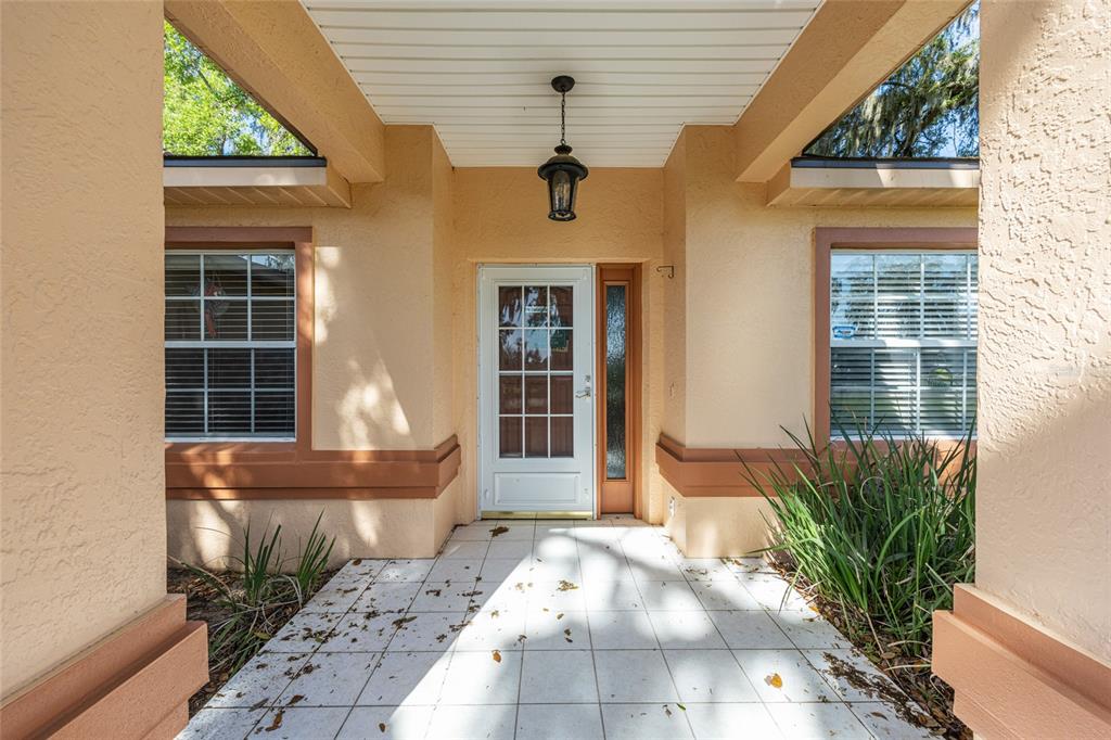 10090 Southwest 78th Court Ocala, FL 34476 - Photo 8 of 52 a front view of a house with garden