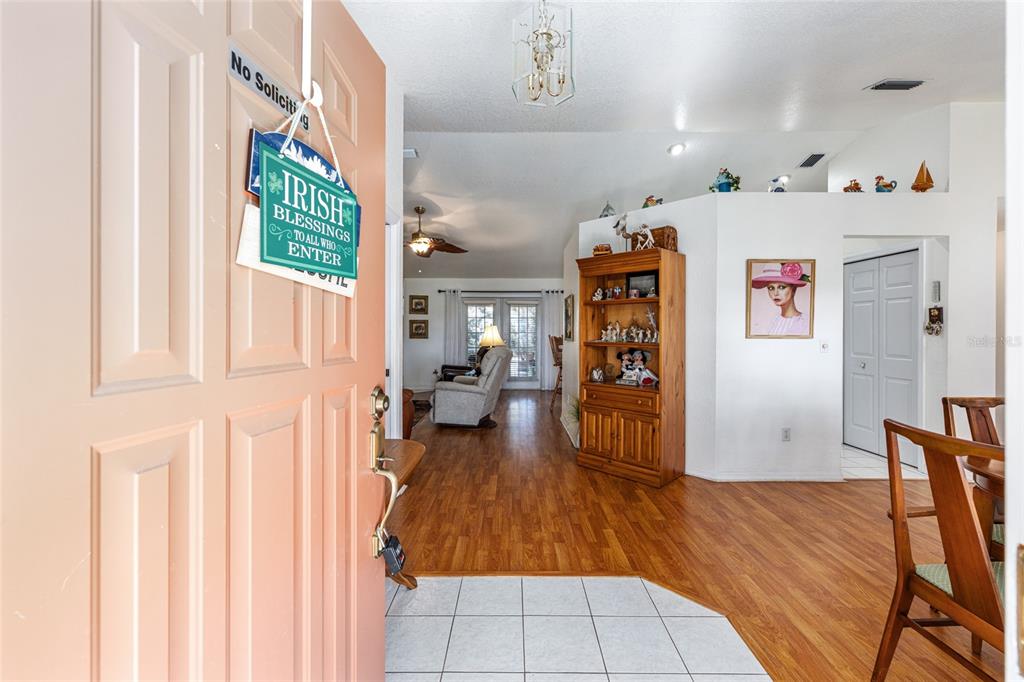 10090 Southwest 78th Court Ocala, FL 34476 - Photo 9 of 52 a view of an entryway with furniture cabinet and wooden floor