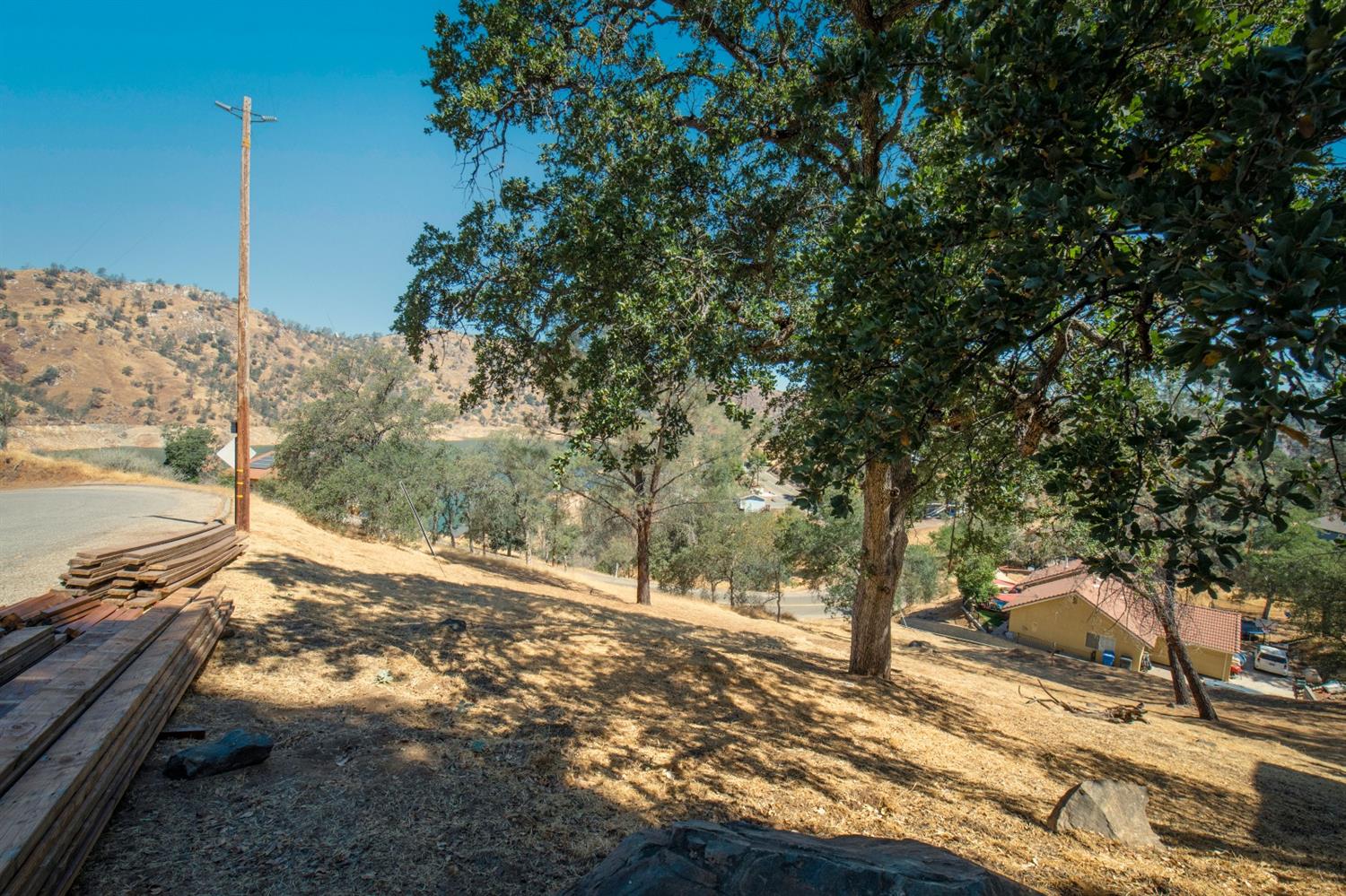 28486 Perkins Road Friant, CA 93626 - Photo 3 of 6 a view of a yard with trees