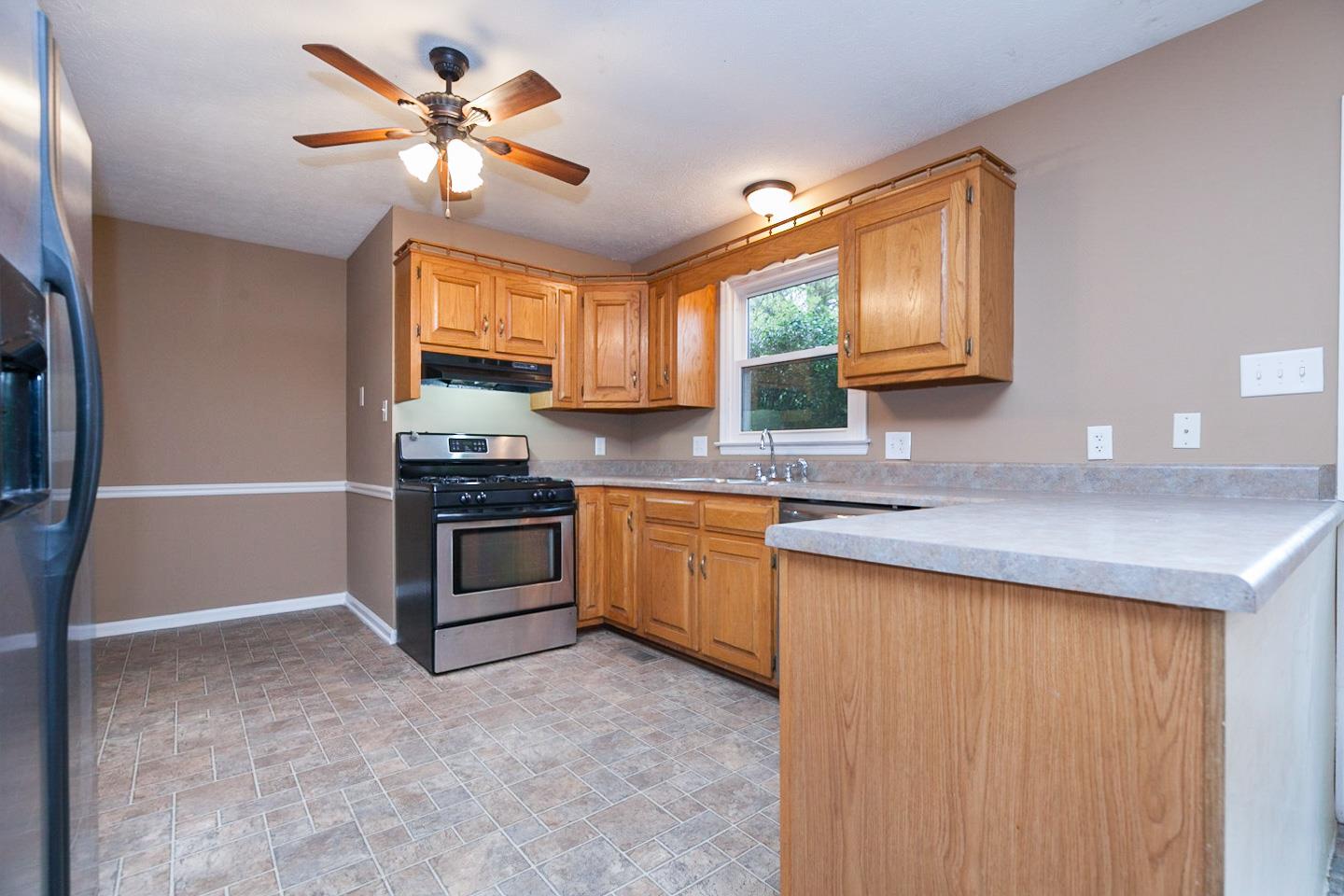 794 Spring Circle Springfield, TN 37172 - Photo 2 of 16 a kitchen with granite countertop a stove a sink and a refrigerator