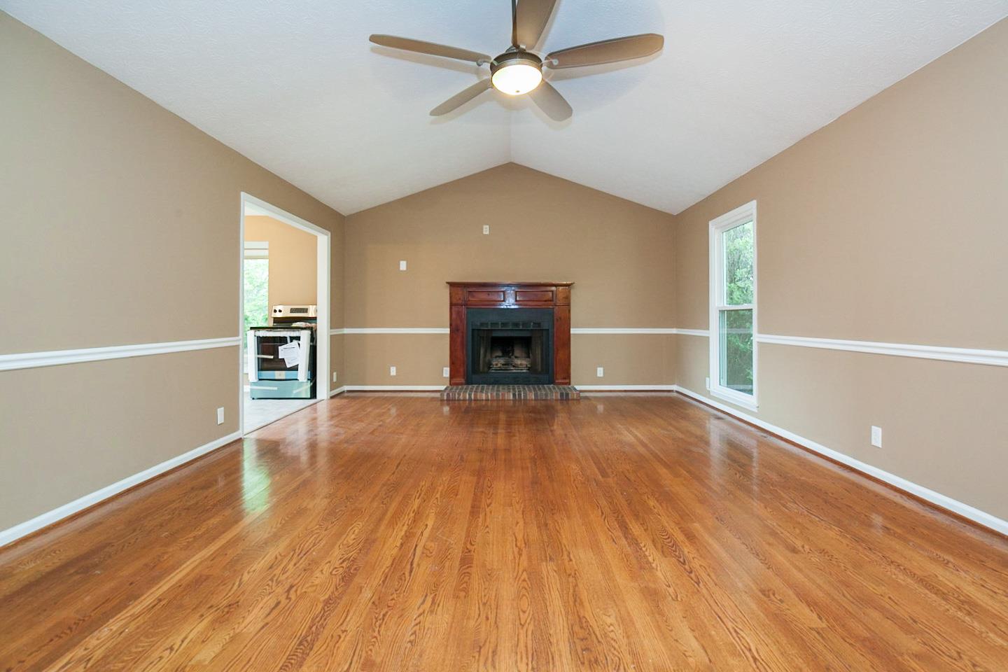 794 Spring Circle Springfield, TN 37172 - Photo 4 of 16 wooden floor fireplace and windows in an empty room