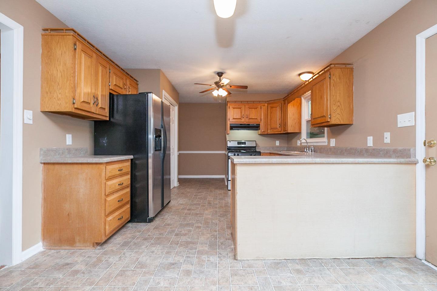 794 Spring Circle Springfield, TN 37172 - Photo 6 of 16 a kitchen with stainless steel appliances granite countertop a refrigerator a stove and a sink